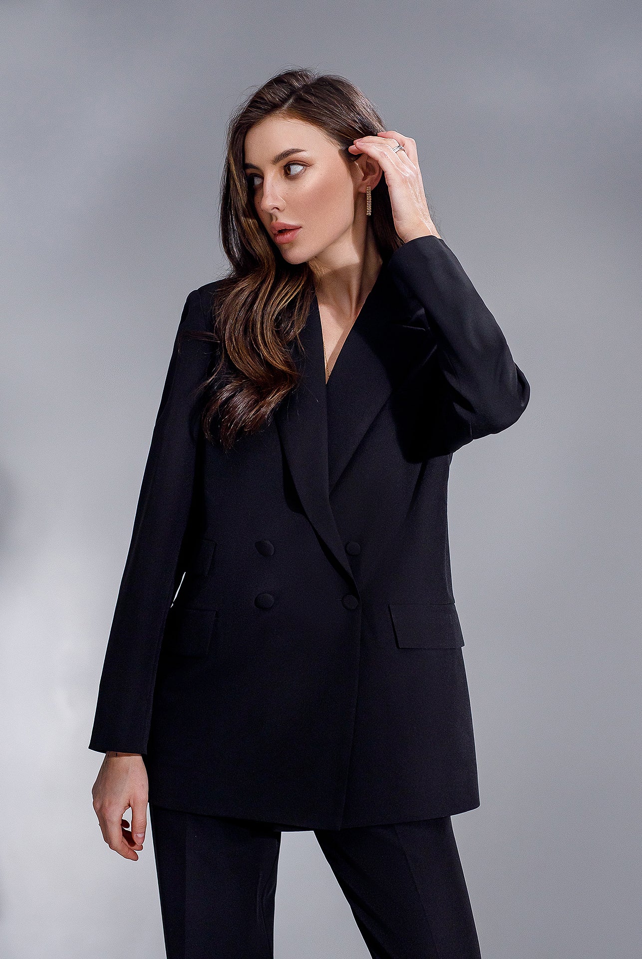 ELAGIA black double-breasted suit detail shot of trouser fit and hemline with professional styling