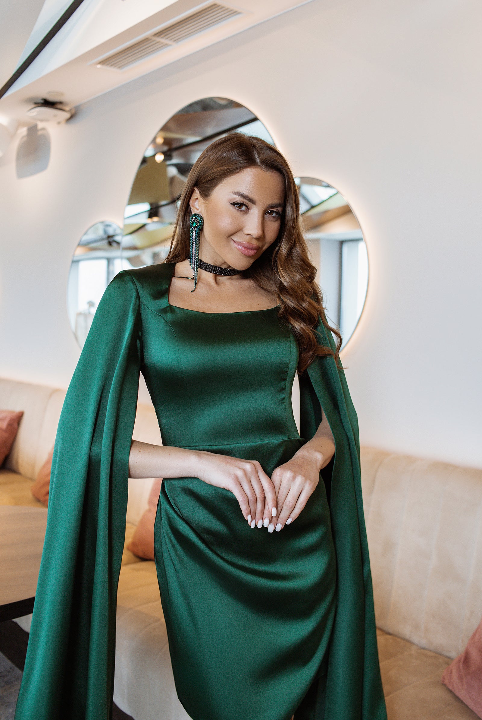 ELAGIA Emerald Satin Cloak Sleeve Mini Dress detail shot of flowing cape sleeves - 3 piece women's suit design