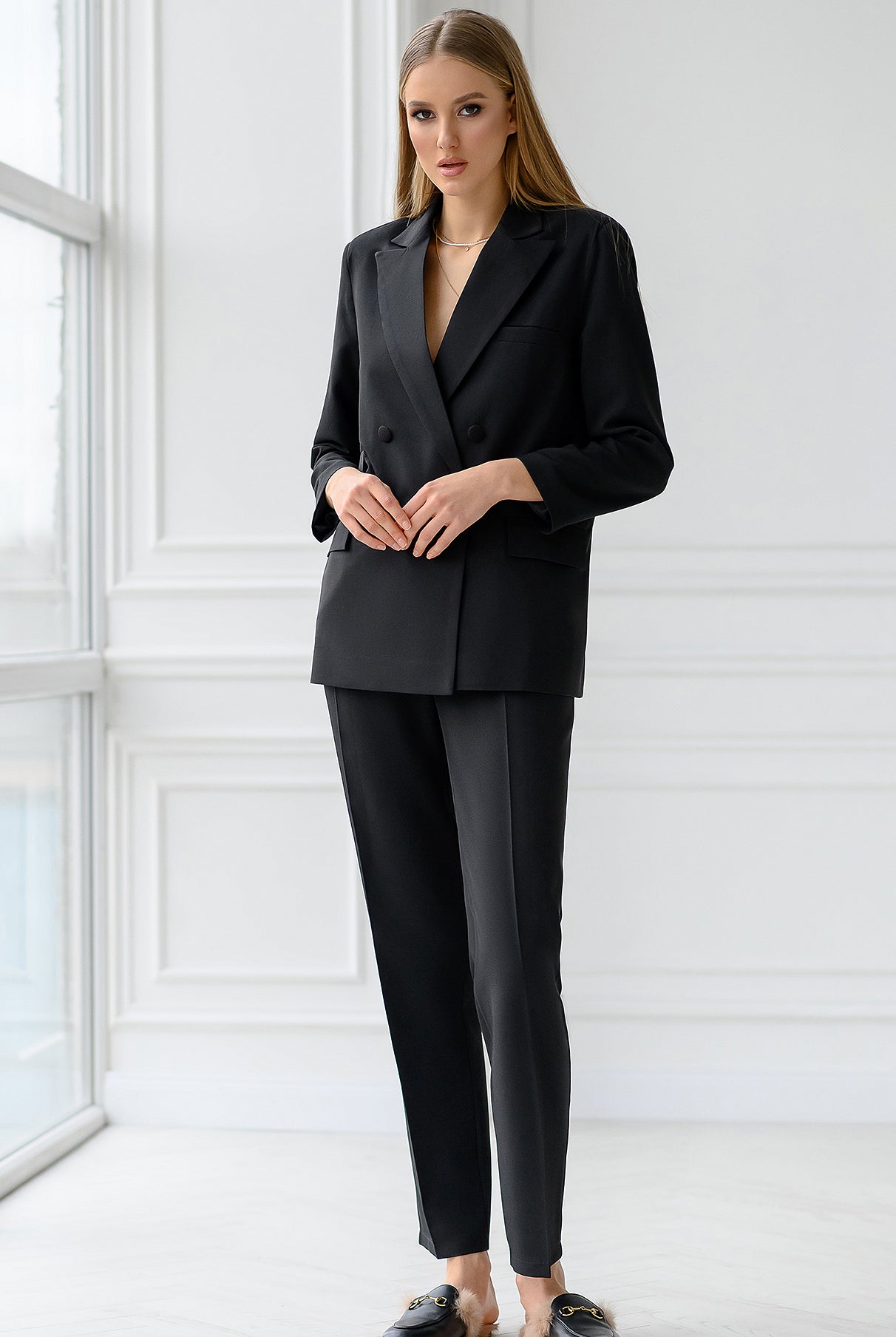 ELAGIA black double-breasted suit worn by model in office setting - 3 piece women's suit style inspiration