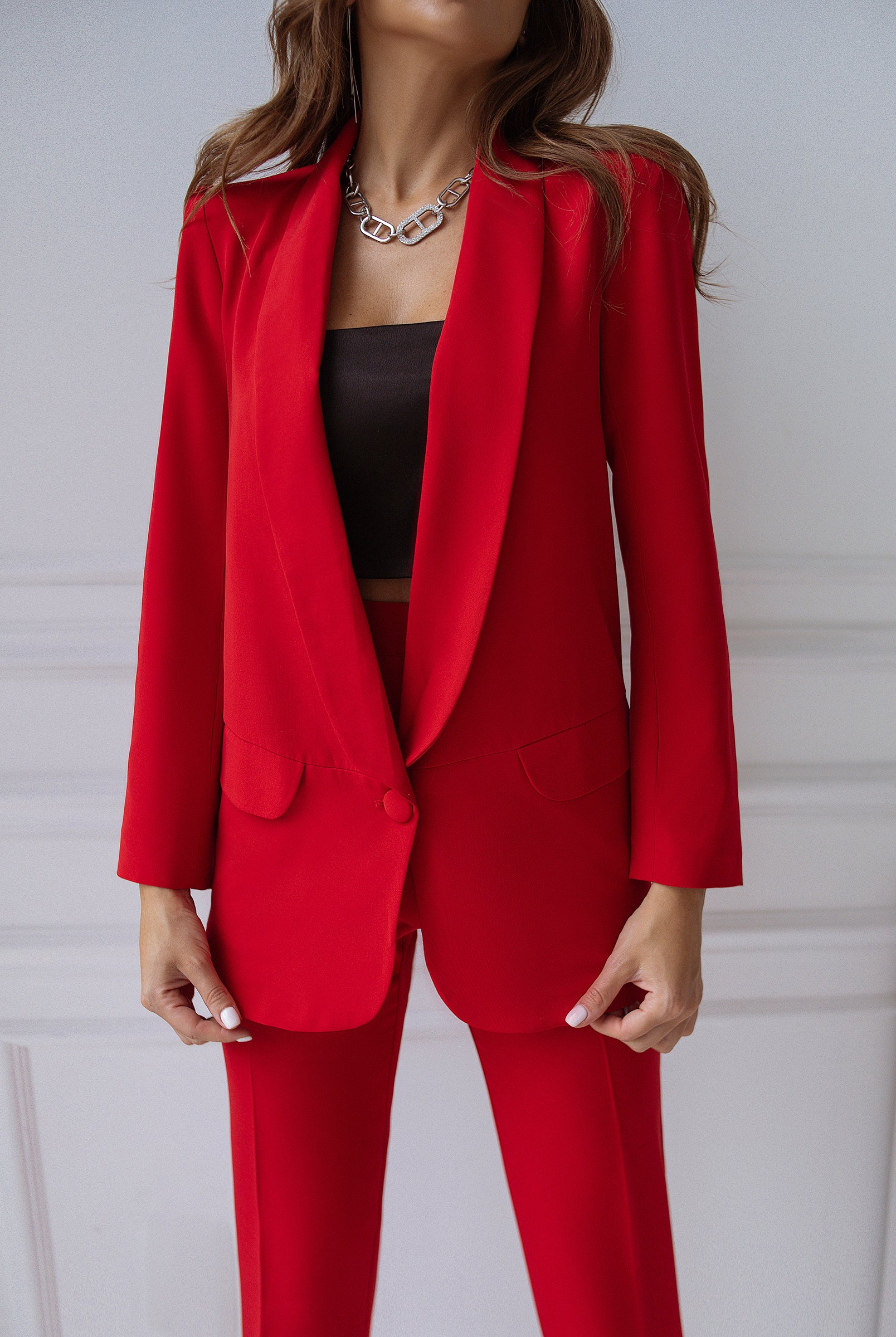 ELAGIA red 3 piece women's suit lifestyle shot - professional businesswoman in tailored blazer and pants
