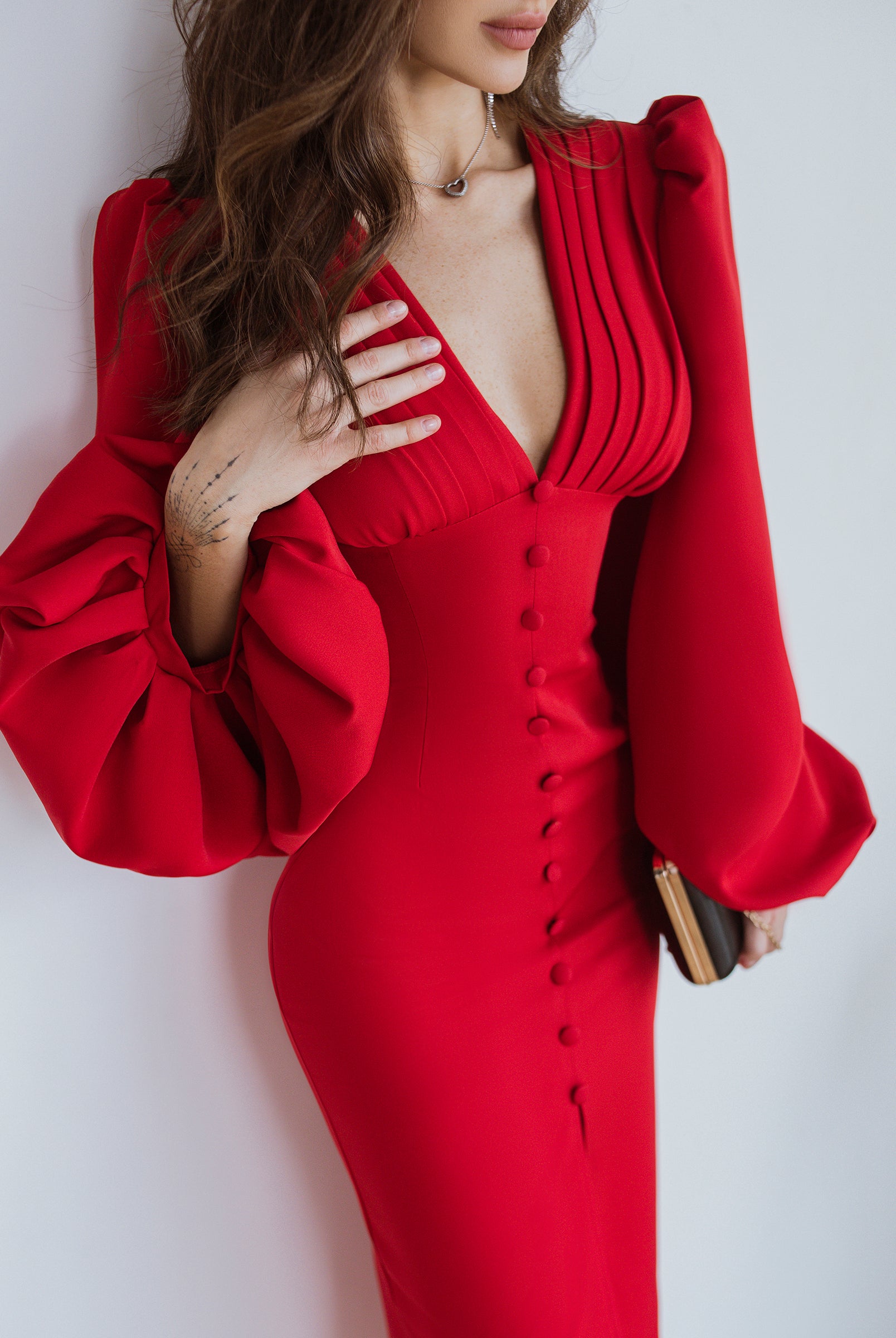 ELAGIA Red Backless Puff Sleeve Midi Dress detail shot of dramatic puff sleeves with 3 piece women's suit vibes