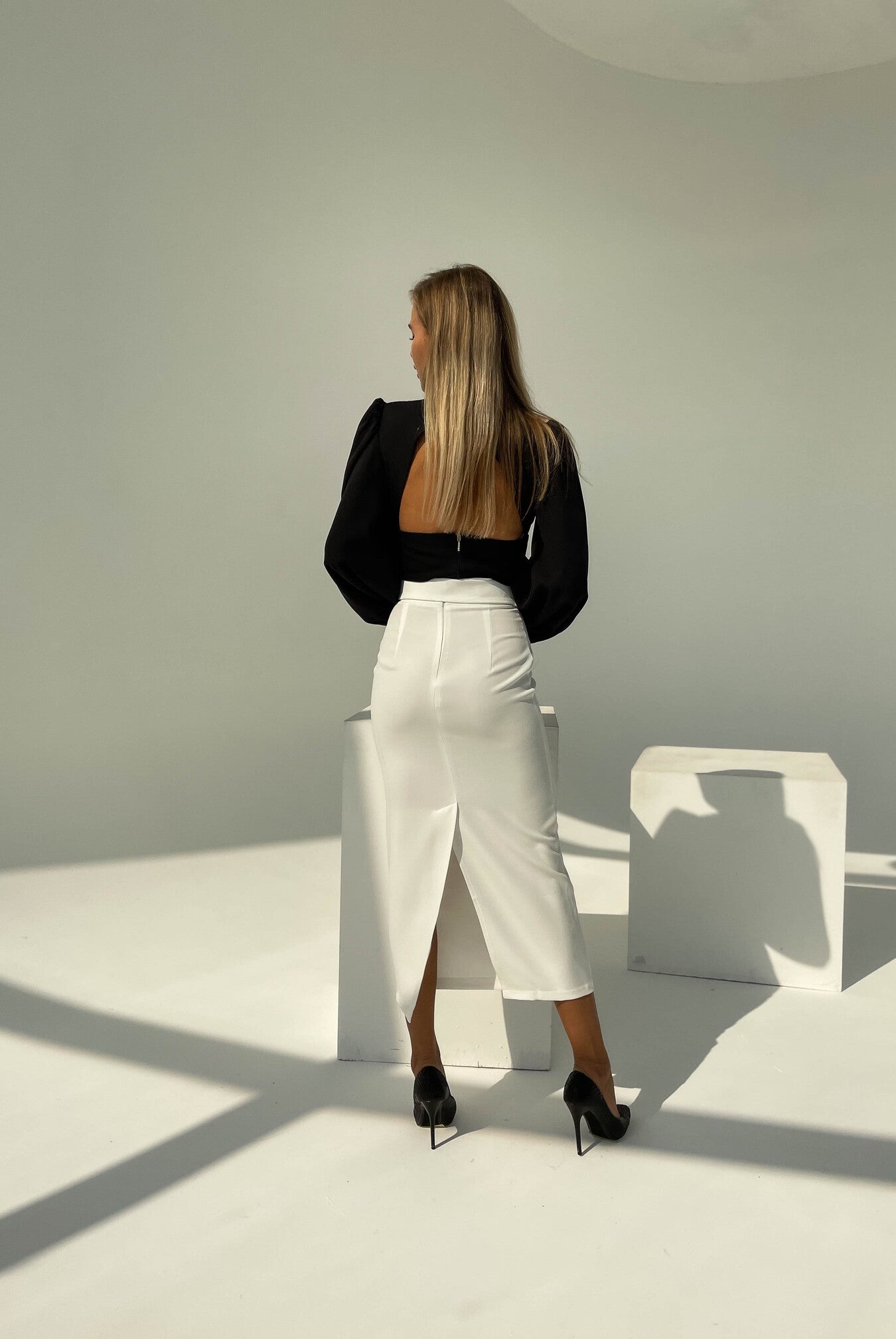 ELAGIA white high waist pencil skirt side angle displaying white suit for women silhouette and construction