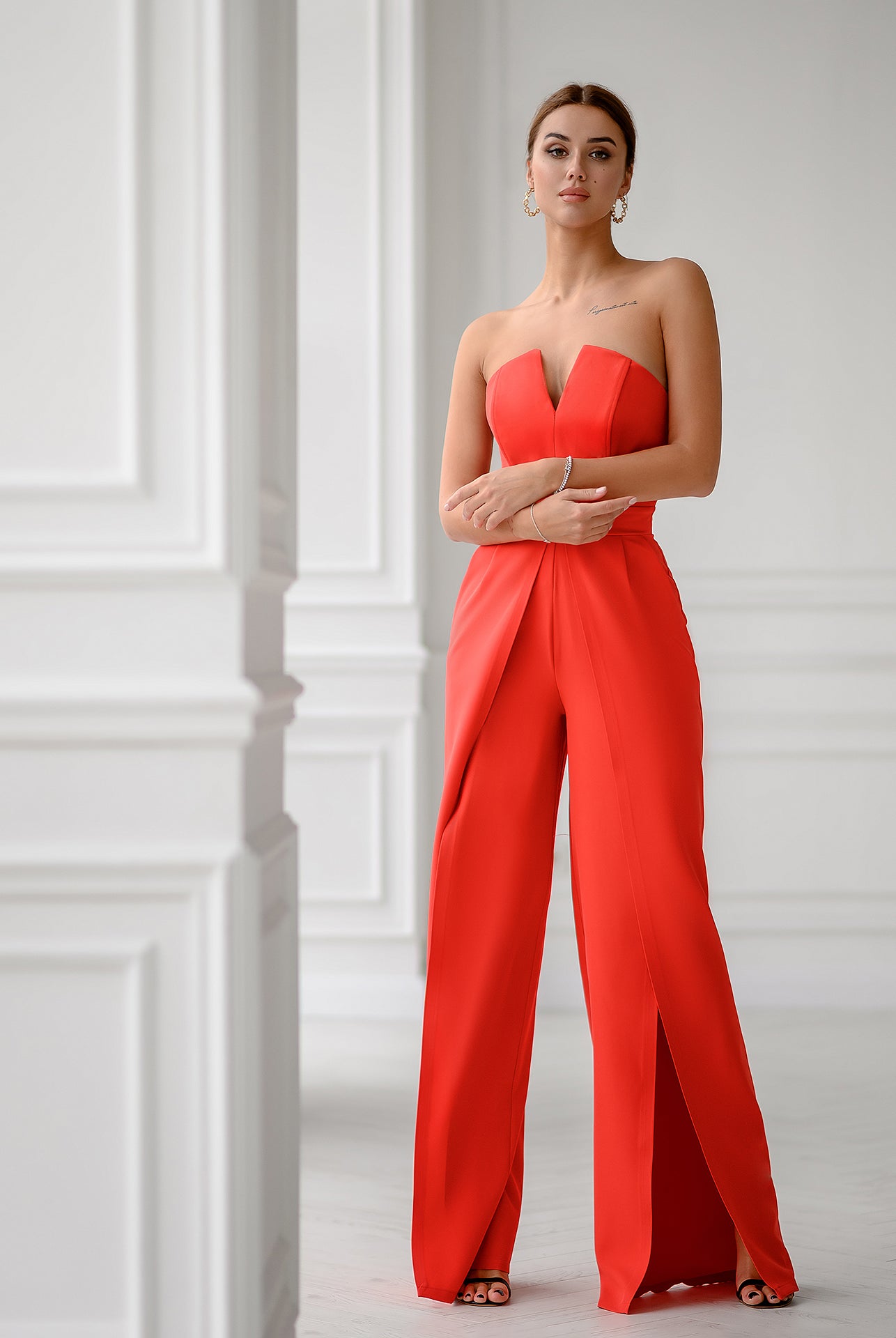 ELAGIA coral jumpsuit back view showing strapless design and flowing wide-leg pants on model