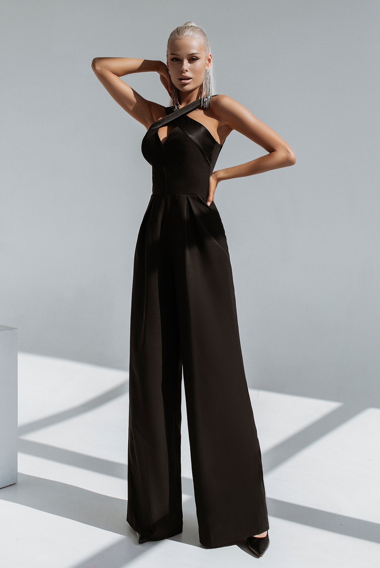 ELAGIA Black Cross-Neck Sleeveless Jumpsuit detail shot, womens black suit crossover neckline close-up