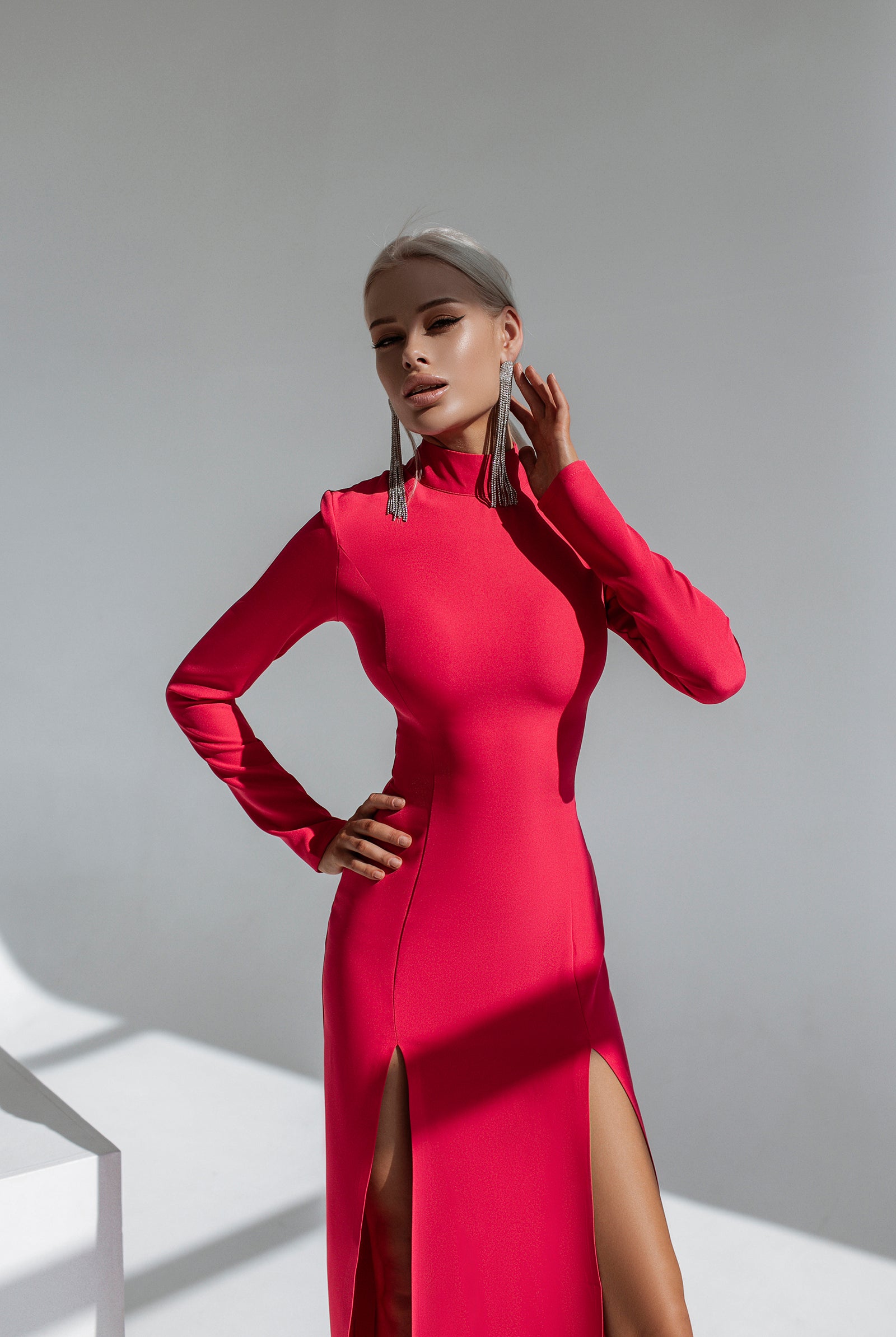 ELAGIA crimson high neck side-slit midi dress lifestyle shot showcasing 3 piece women's suit versatility