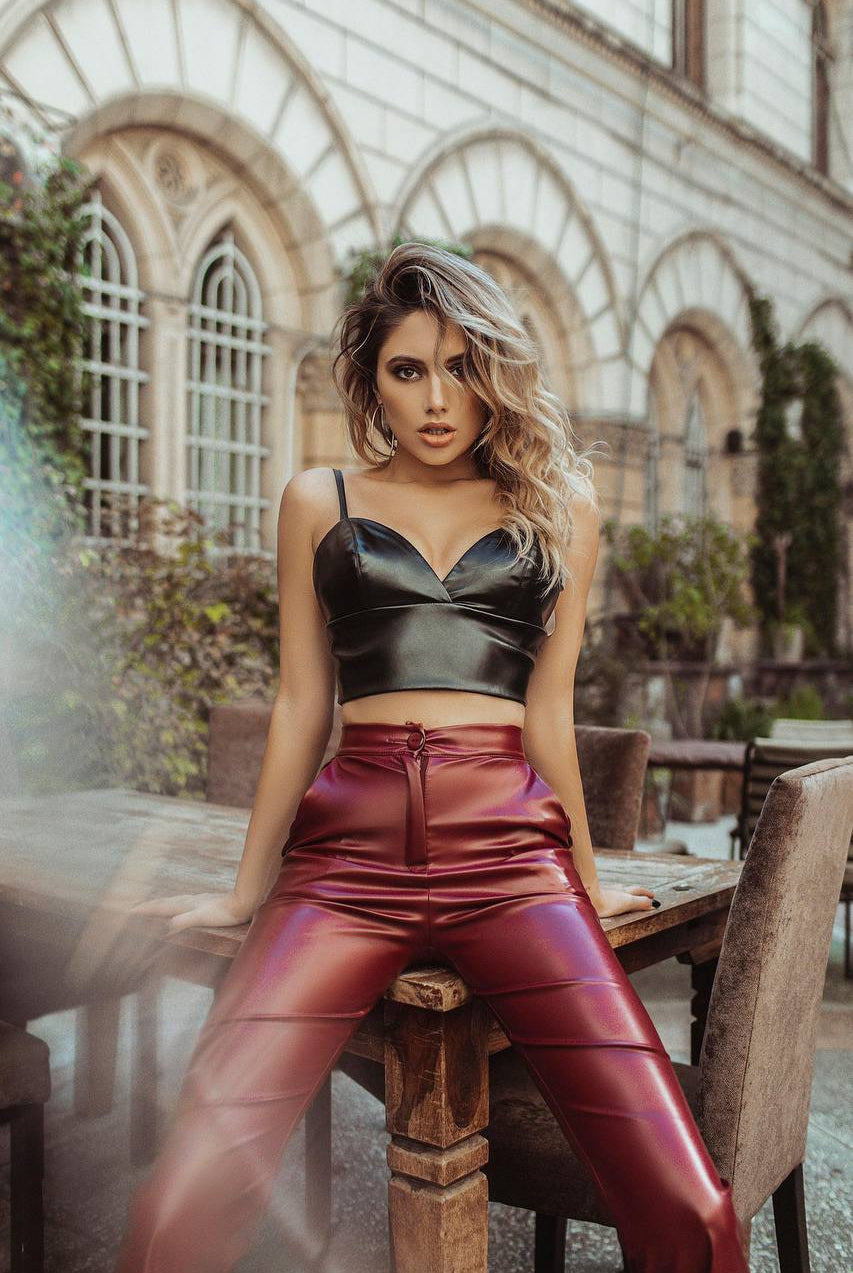 ELAGIA Black Vegan Leather Crop Top flat lay - women's black suit set top displayed on neutral background