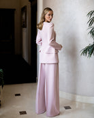 Pink square-neck double-breasted suit in crepe fabric, back view displaying clean lines and fitted silhouette