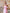 Pink strapless neck scarf draped maxi in crepe fabric, side view highlighting corseted silhouette