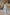 ELAGIA sky-blue sleeveless V-neck jumpsuit lifestyle shot - light blue suit women worn in natural setting