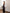 Black satin strapless peplum sheer skirt maxi with corseted bodice, back view