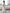 Céline White Off-Shoulder Draped-Bow Midi Dress - side view | ELAGIA
