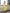 Céline Yellow Off-Shoulder Draped-Bow Midi Dress - front view | ELAGIA