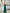 ELAGIA blue jumpsuit side angle view - Emerald Strapless V-Neck Jumpsuit profile showing silhouette