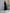 ELAGIA black V-neck puff-sleeve midi dress detail shot of structured puff sleeves and V-neckline construction