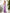 ELAGIA blue jumpsuit inspired purple strapless design photographed from three-quarter angle view