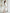 ELAGIA white one-shoulder belted midi dress side angle highlighting asymmetrical shoulder design and belt