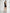 ELAGIA black one-shoulder fringed mini dress - hemline detail shot with 3 piece women's suit elegance