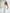 ELAGIA white one-shoulder belted midi dress detail shot of fabric texture and tailored construction