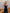 ELAGIA women's black suit set lifestyle shot of model wearing sleeveless V-neck jumpsuit in office setting