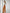 ELAGIA white ribbed-knit wrap crop top close-up detail - white suit for women top highlighting knit pattern