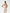 ELAGIA beige v-neck sleeveless jumpsuit detail shot of blue jumpsuit style v-neckline and waist tie