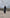 ELAGIA black long sleeve thigh-slit maxi dress back view showing flowing silhouette and zipper closure