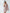 ELAGIA beige one-shoulder feather sleeve mini dress fabric detail showing 3 piece women's suit quality