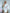 ELAGIA white one-shoulder feather sleeve mini dress - three-quarter view emphasizing dress length and silhouette