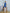 ELAGIA blue one-shoulder mini dress side angle highlighting the modern asymmetrical cut and tailored fit