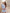 ELAGIA sky-blue one-shoulder satin mini dress - three-quarter view showing drape and movement