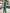 ELAGIA green double breasted suit back view showing tailored fit of 3 piece women's suit blazer and trouser silhouette