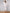 ELAGIA white one-shoulder belted midi dress, styled look showing full silhouette and elegant draping