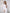 ELAGIA white one-shoulder belted midi dress, back detail view showing clean lines and belt placement