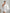 ELAGIA white one-shoulder feather sleeve mini dress - movement shot capturing feather sleeve flow and drape