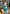 Model wearing ELAGIA Emerald Satin Long Sleeve Maxi Dress in motion, showcasing dress movement