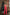 ELAGIA red suit womens - close-up detail view of deep V-neck sleeveless jumpsuit fabric and fit