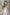 ELAGIA white suit for women lifestyle shot - model in sleeveless V-neck jumpsuit walking pose