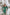 Studio shot of ELAGIA Emerald Satin Long Sleeve Maxi Dress on hanger displaying full silhouette