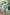 ELAGIA green puffed sleeve dress close-up detail of balloon sleeves and midi length hemline construction