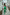 ELAGIA Monika Green Backless Jumpsuit front view - striking womens green suit with contemporary design