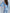 ELAGIA model wearing sky-blue sweetheart top & flared pants set in office setting