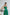 ELAGIA emerald green jumpsuit detail shot highlighting luxurious satin fabric texture and drape