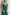 ELAGIA emerald green jumpsuit back view showing flowing wide-leg design and satin finish