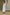 ELAGIA white one-shoulder belted midi dress modeled in lifestyle setting showing full length and fit