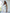 ELAGIA white one-shoulder belted midi dress front view - elegant asymmetrical neckline and waist tie detail