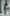 ELAGIA Monika Green Backless Jumpsuit - waist detail showing belt and silhouette of womens green suit