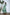 ELAGIA green thigh-slit maxi dress side angle highlighting dramatic thigh-high slit and fitted bodice