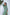 ELAGIA green thigh-slit maxi dress detail shot of slit opening and fabric drape on model