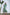 ELAGIA green thigh-slit maxi dress back view showing flowing silhouette and zip closure detail