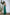 ELAGIA emerald green jumpsuit full-length side angle showing blue jumpsuit proportions